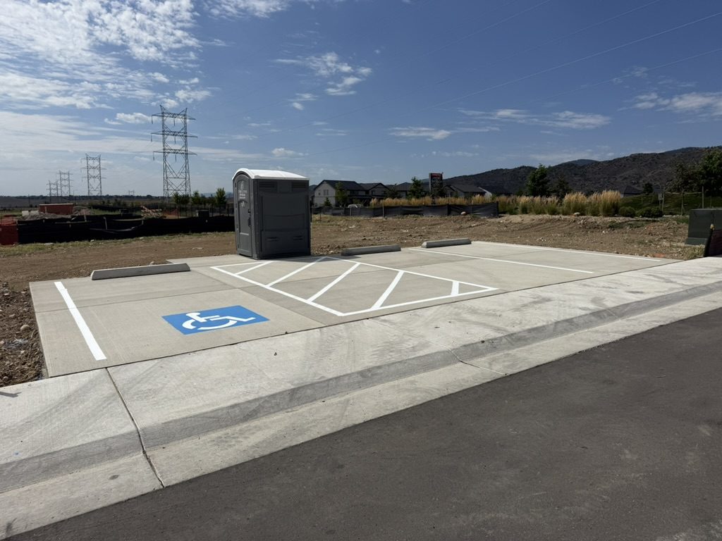 New concrete parking stalls including an ADA space with access aisle